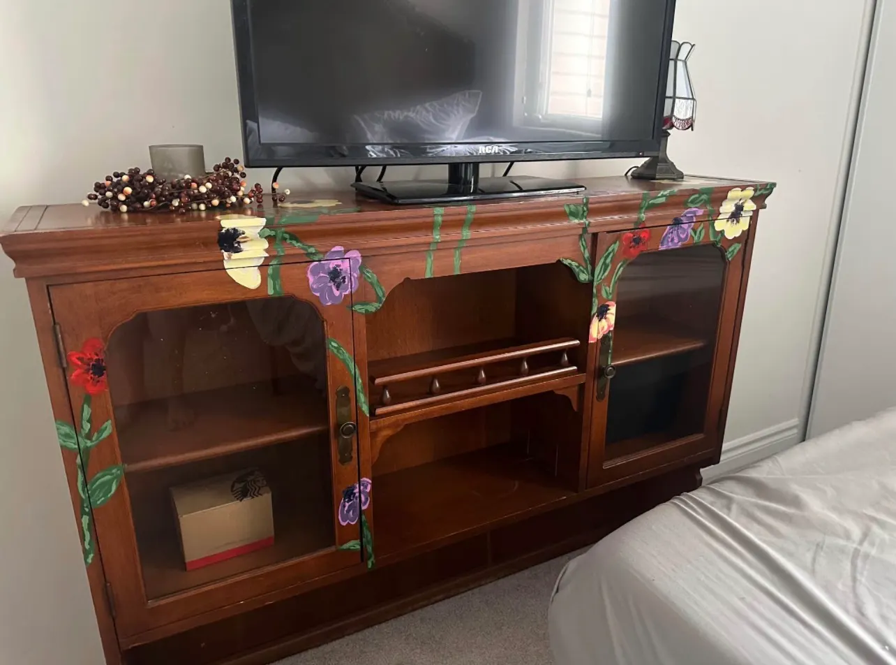 Vintage TV cabinet hand-painted by Courtney Janelle with a climbing floral motif in reds, purples, and yellows