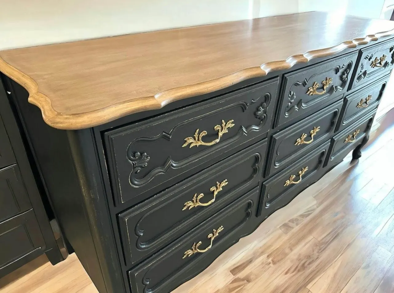 Restored wood dresser corner detail showing brass hardware and refinished grain